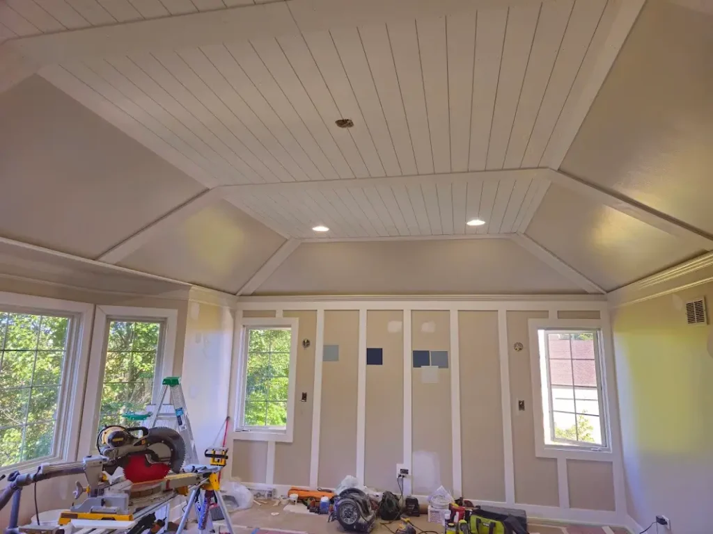 High-end sunroom renovation in St. Charles showing detailed preparation work, custom paneled walls, and specialty shiplap ceiling installation by ACE 123 Contractors