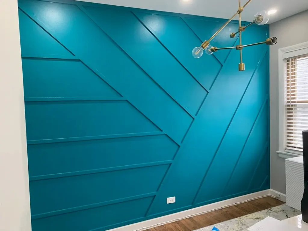 Modern geometric accent wall in Highland Park featuring custom panel design, vibrant teal paint finish, and precision carpentry work by ACE 123 Contractors