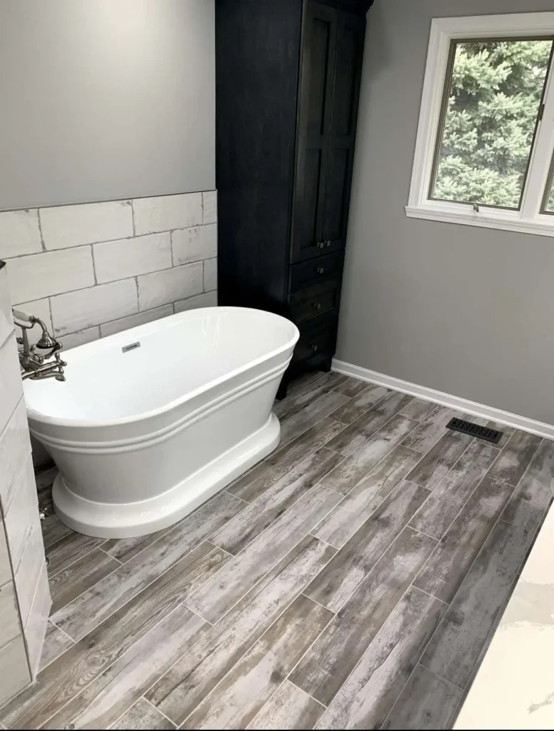 Luxury bathroom renovation in Geneva, IL featuring professional floor and wall tile installation with Schluter waterproofing system for complete moisture protection