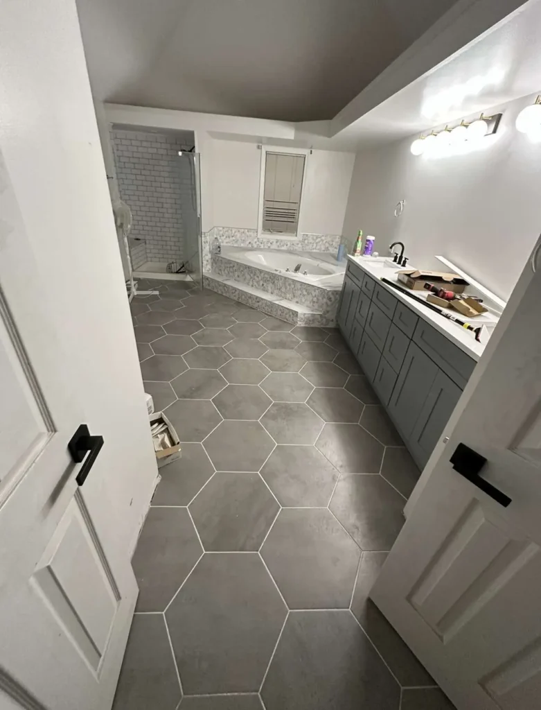 Luxury primary bathroom remodel in Northbrook featuring custom hexagon tile flooring and coordinating shower installation with professional Schluter waterproofing